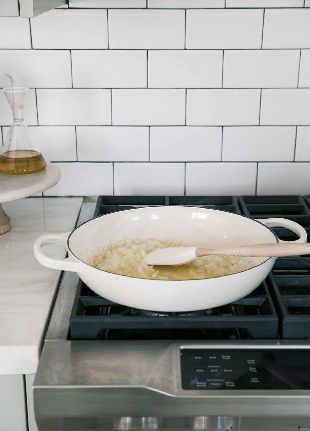 Cooking the onion and garlic in a pan. 