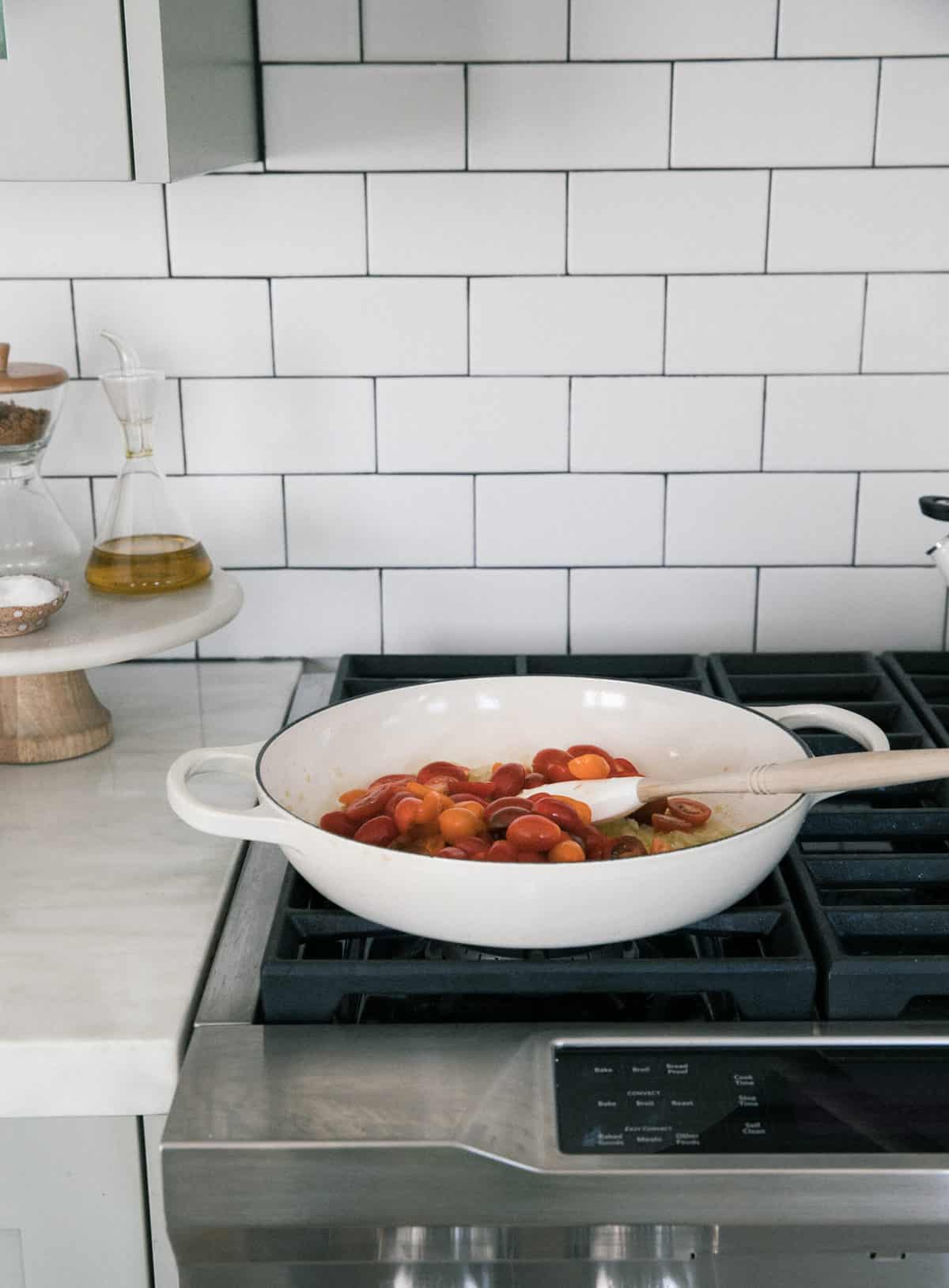 Cooking the tomatoes in a pan. 