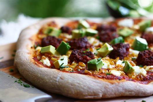 corn chorizo pizza with goat cheese and avocado
