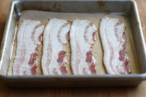 Bacon on a baking sheet pre-baking.