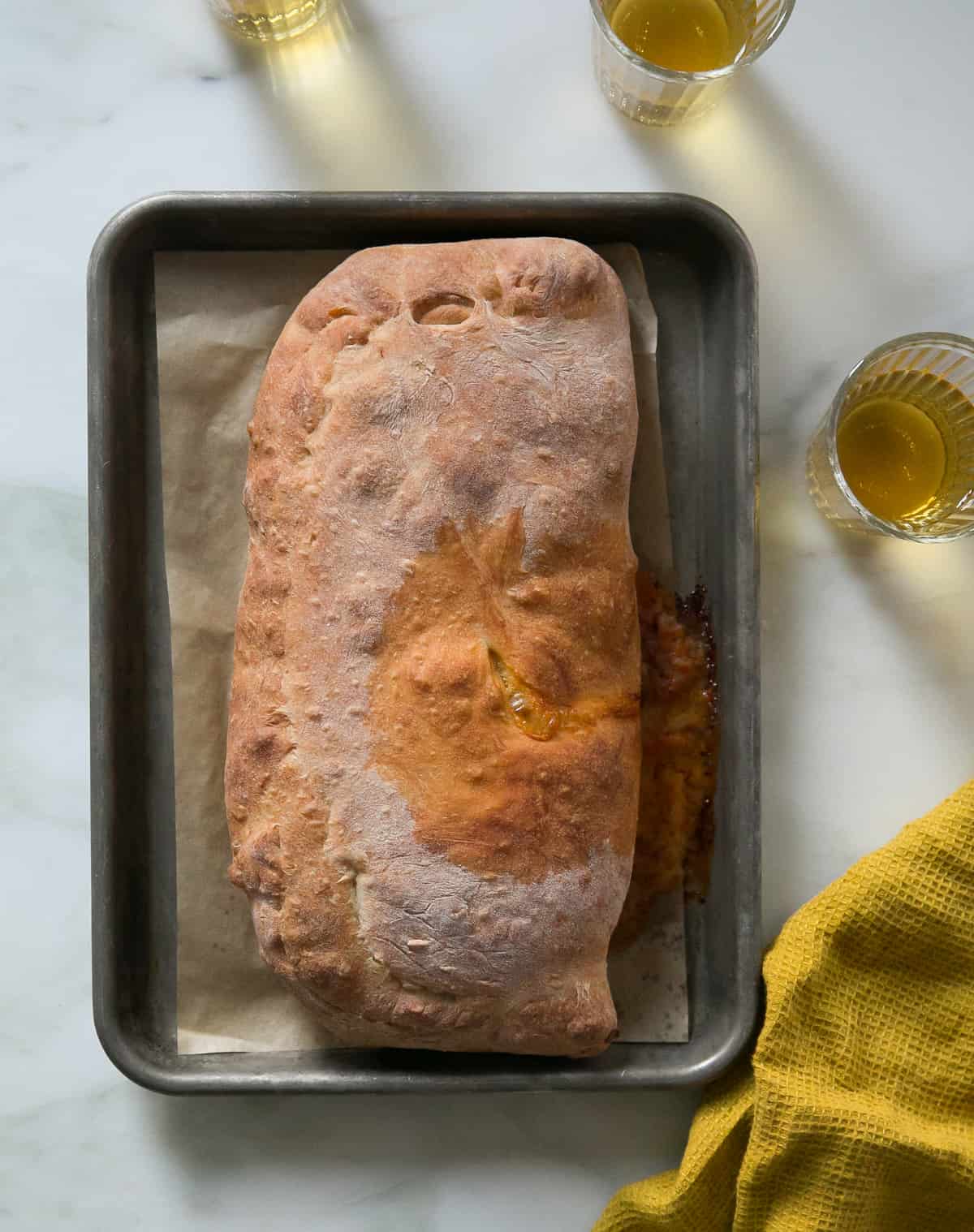 Baked Calzone on baking sheet. 