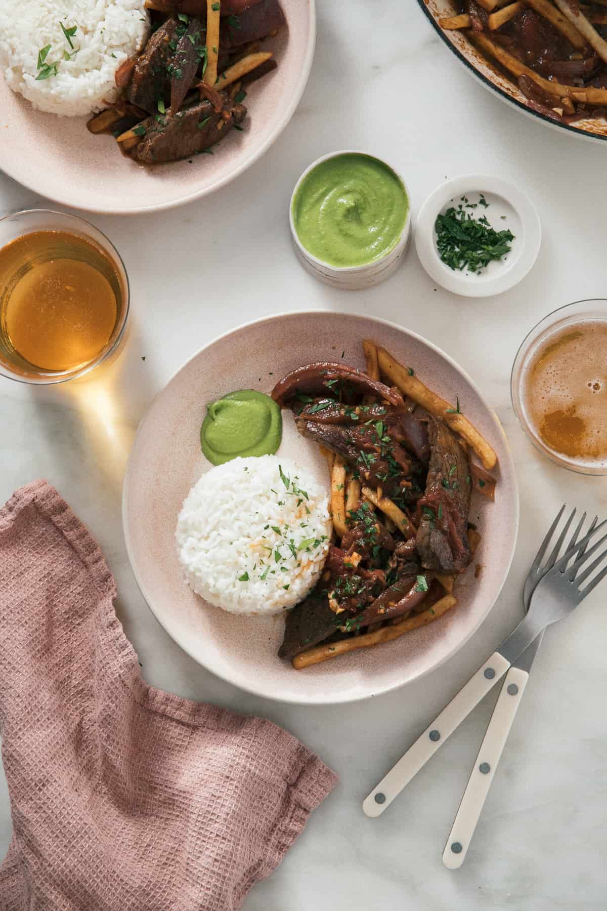 Lomo Saltado in a bowl with rice and aji verde. 