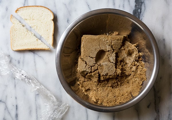 Brown sugar in bowl with bread on the side. 