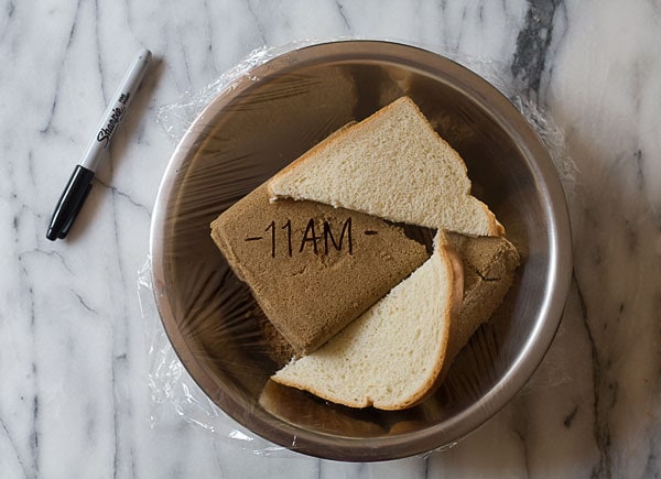 Bowl wrapped in plastic wrap with bread and brown sugar on the inside. 