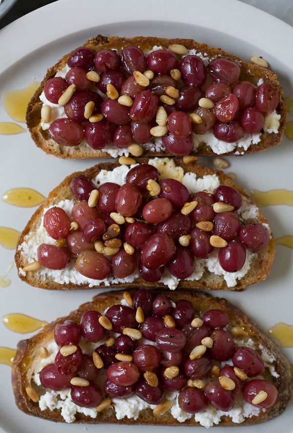 Roasted Grape Ricotta Crostinis with Rosemary and Pinenuts // www.acozykitchen.com