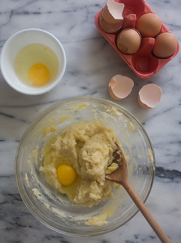 Egg being added to dough. 