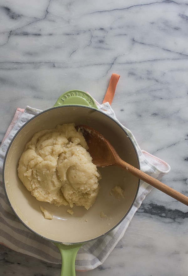 Dough being mixed together in pot. 