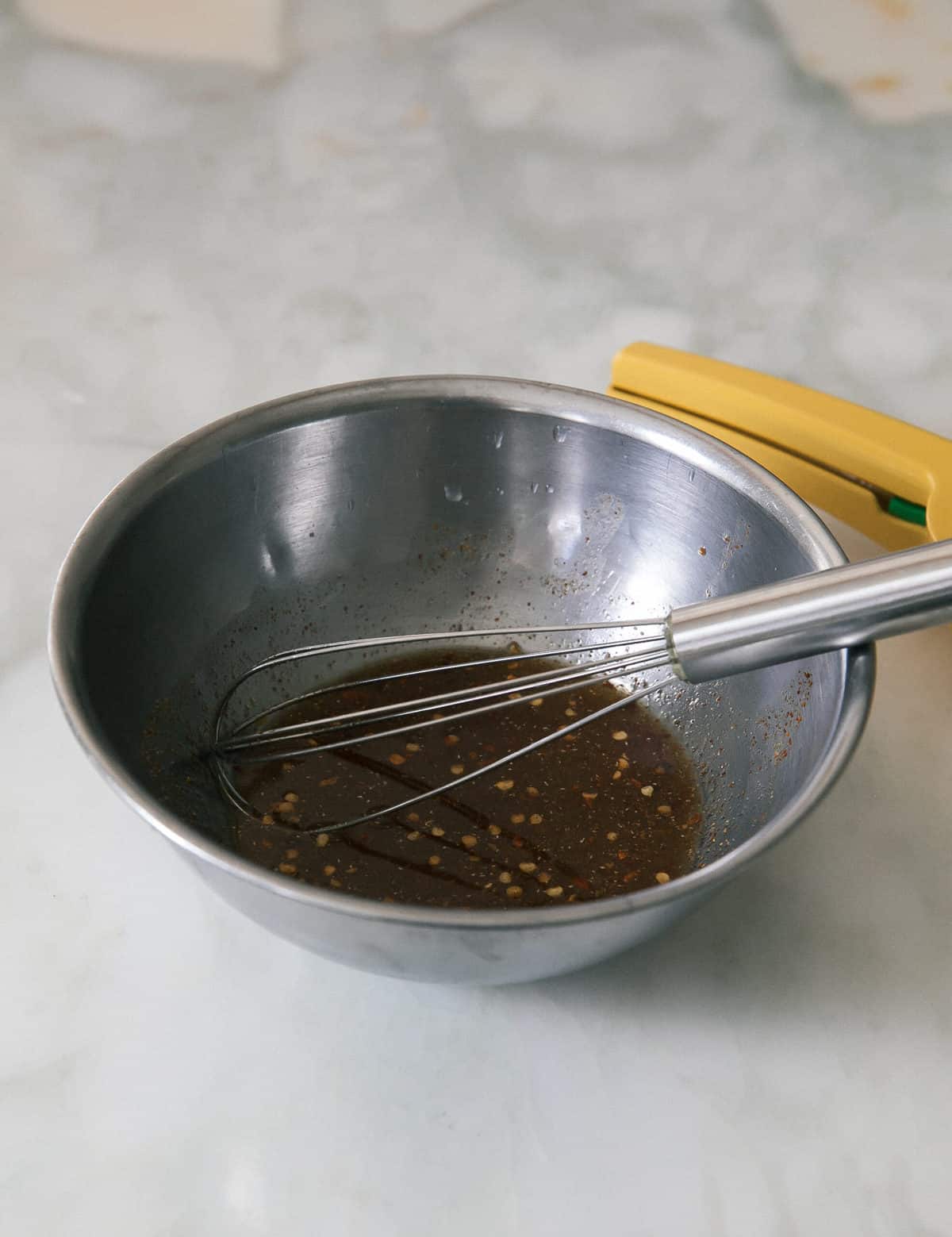 marinade in a bowl with a whisk