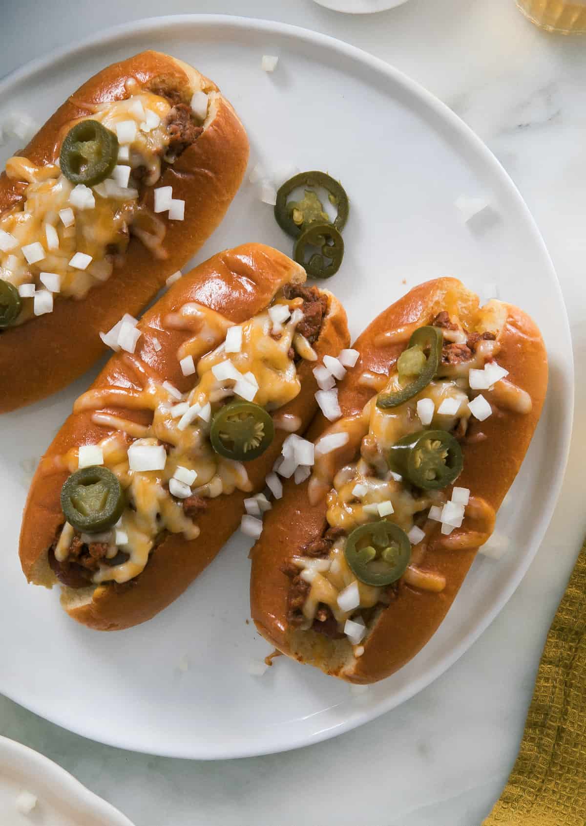 All melty chili cheese dogs with jalapeño and onion on top. 