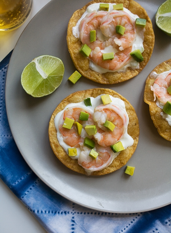 Close up image of a seafood tostada on a plate.