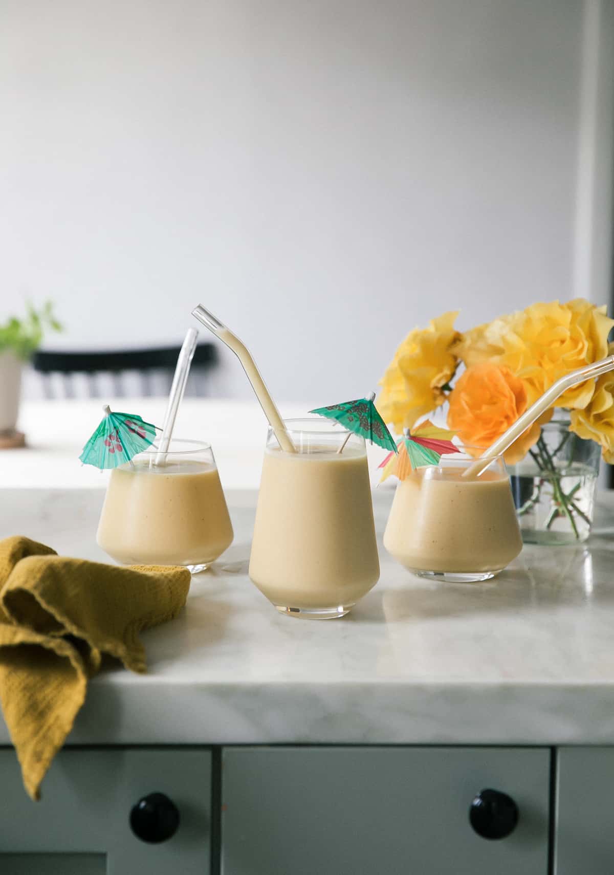 Frozen daiquiris with umbrellas and glass straws