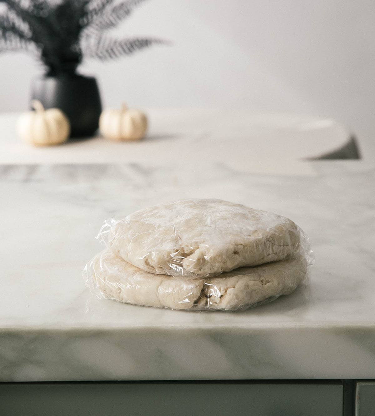 Pie crust that is prepared wrapped in plastic wrap. 