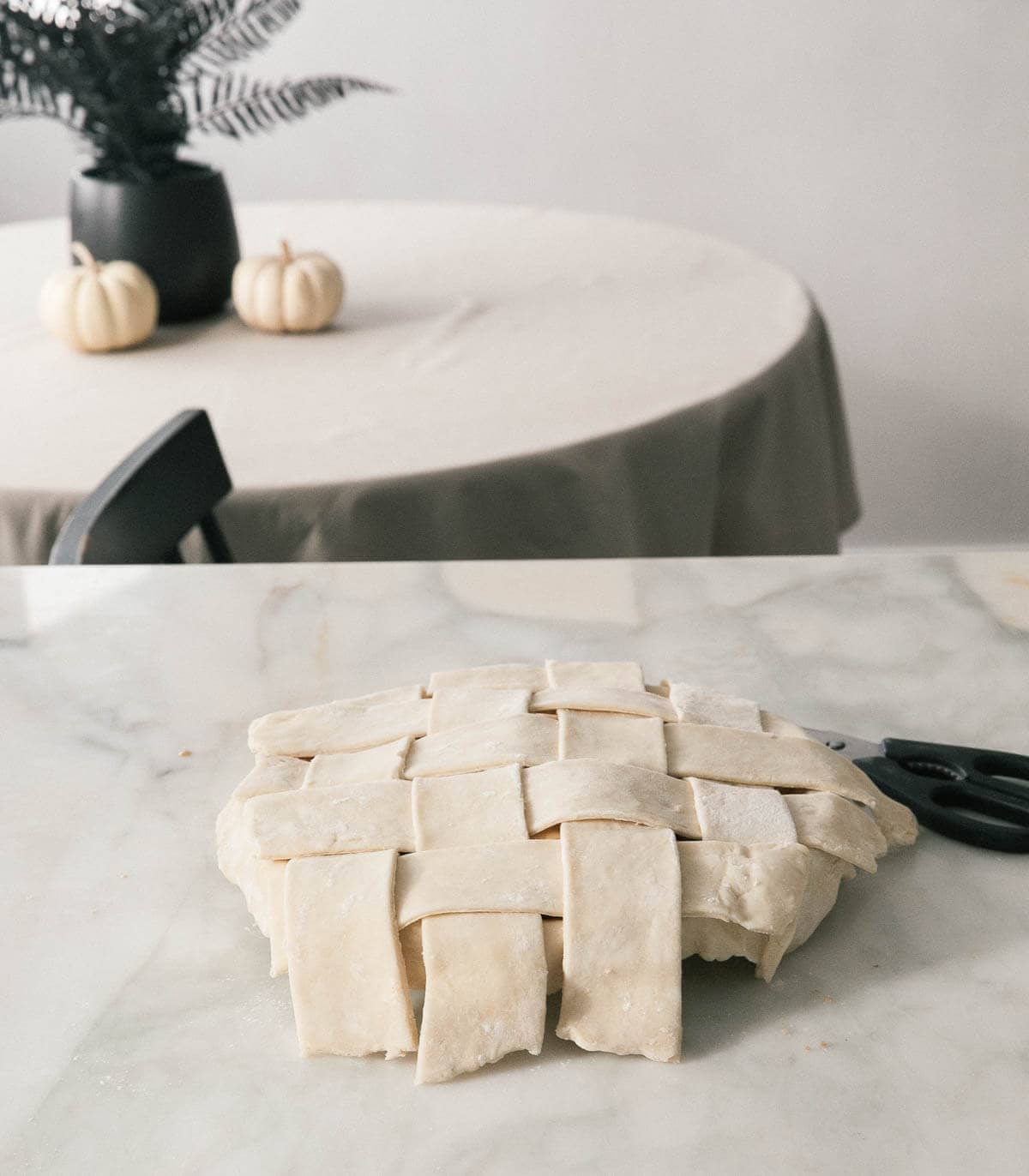 Lattice topped pie about to be trimmed. 