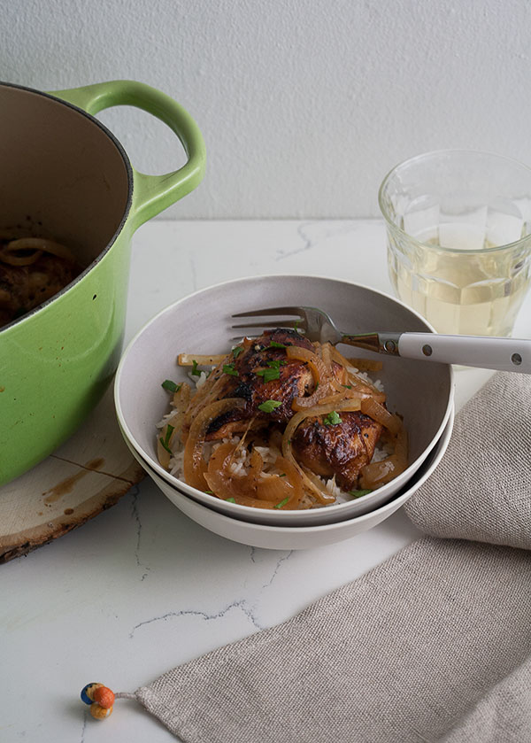 Close up image of pollo frito a la criolla in a bowl with a fork.