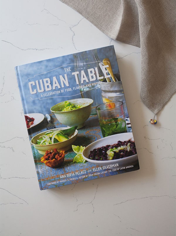 Cuban cookbook on a table with a napkin.