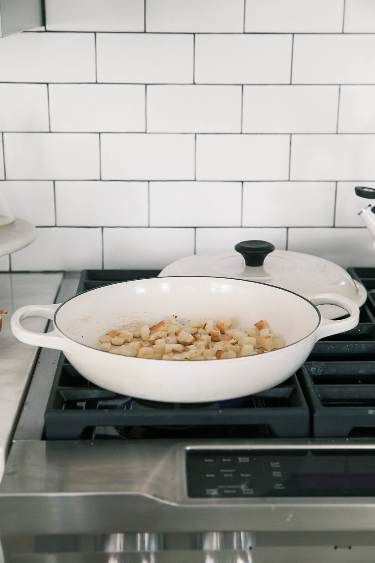 Fried diced potato in pan. 