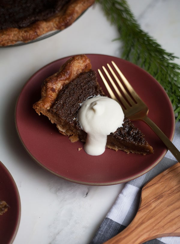 Gingerbread Cookie Pie with a slice and dollop of heavy cream.