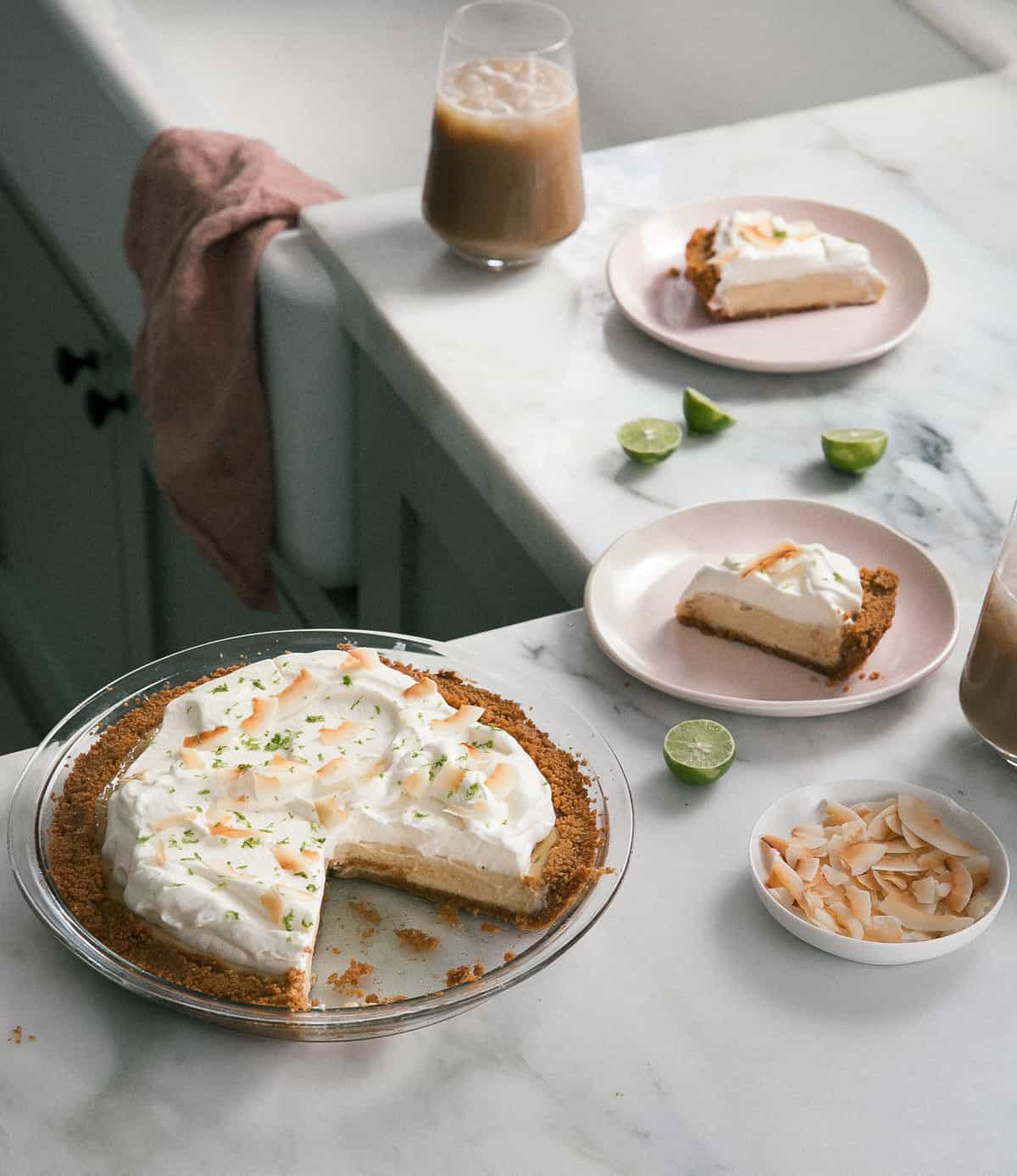 Key Lime Pie on a counter with a slice removed. 