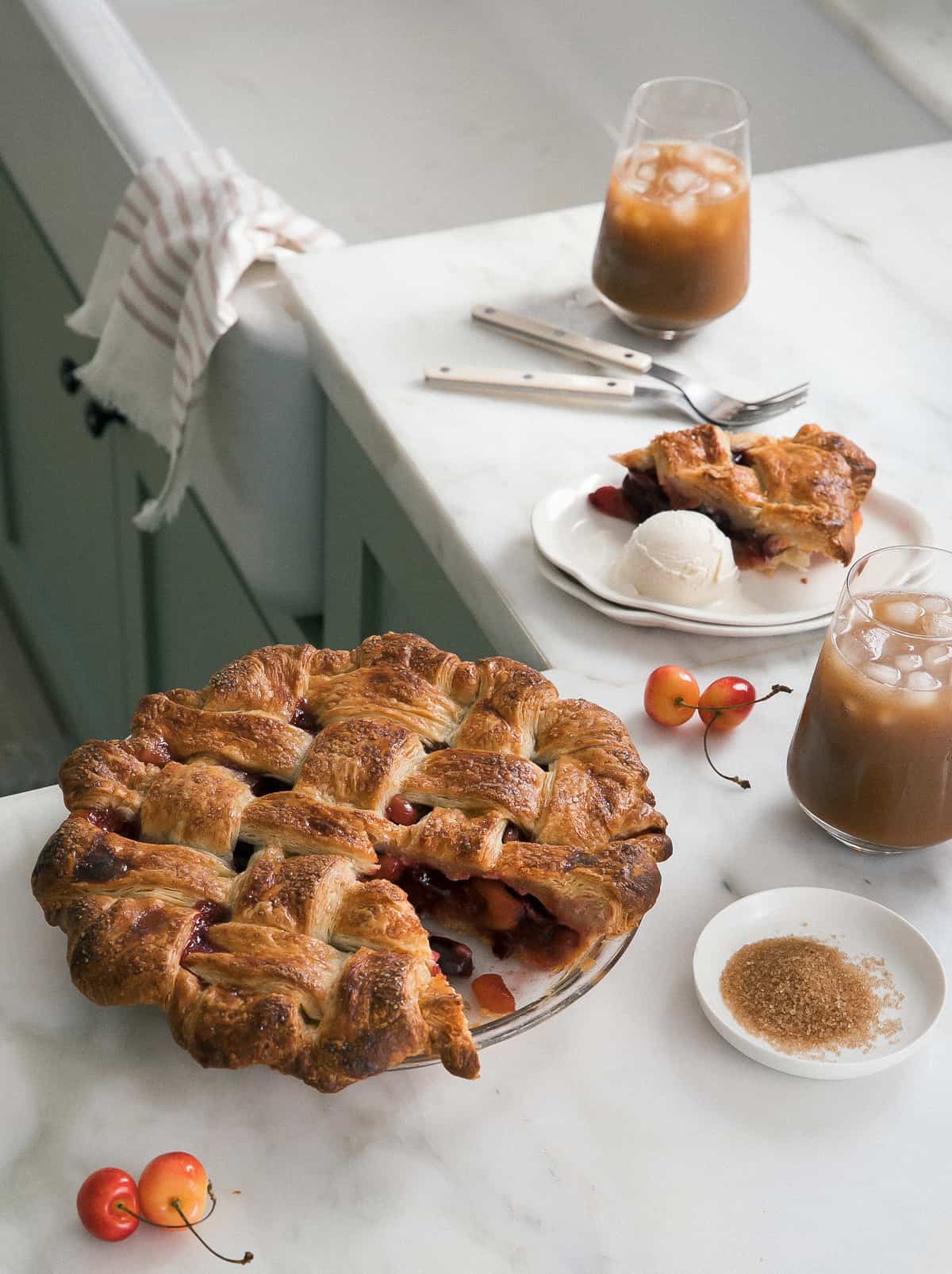 A classic cherry pie in pie pan with slice missing.