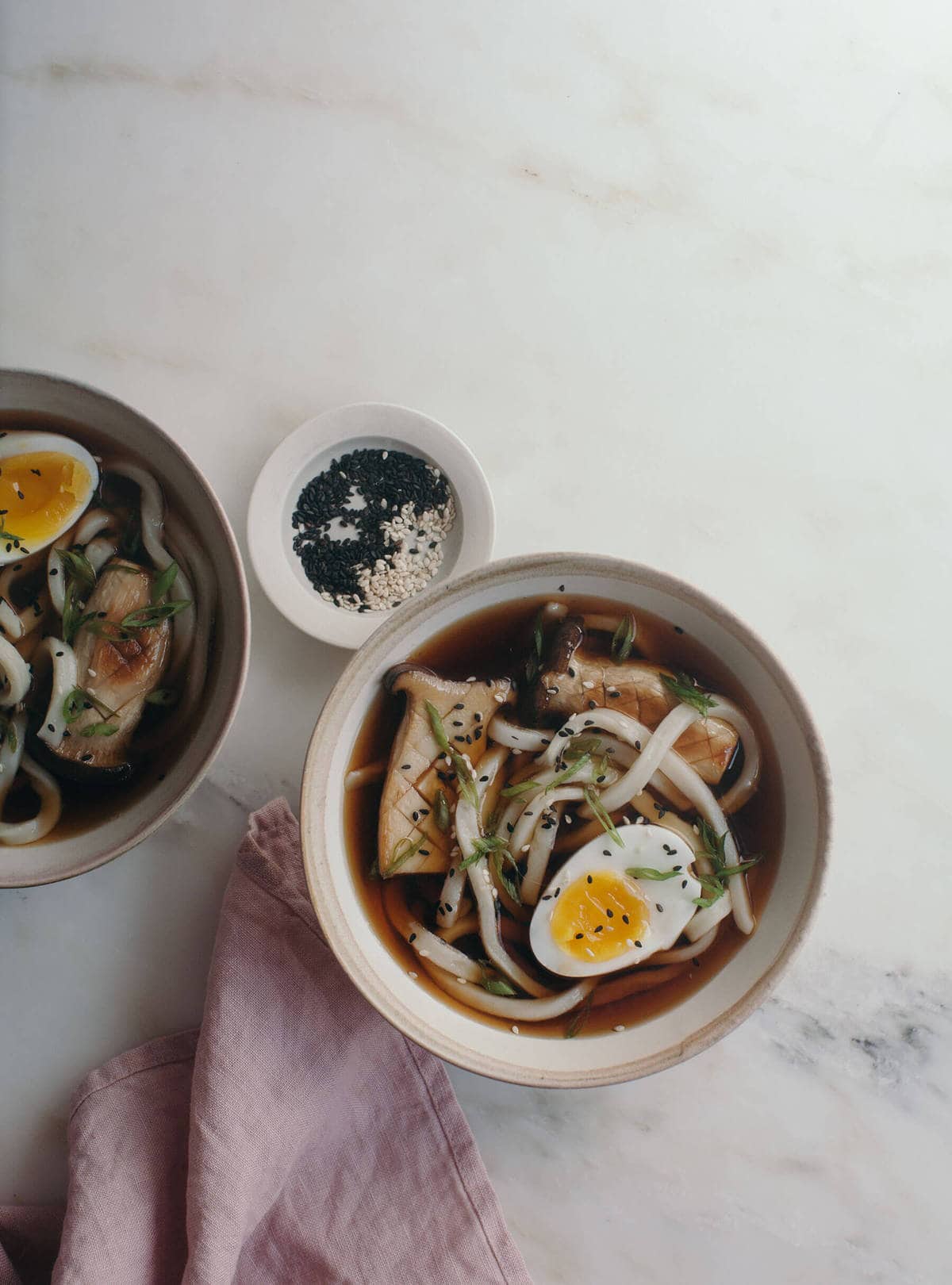 cold udon noodles in a soy broth with king mushrooms