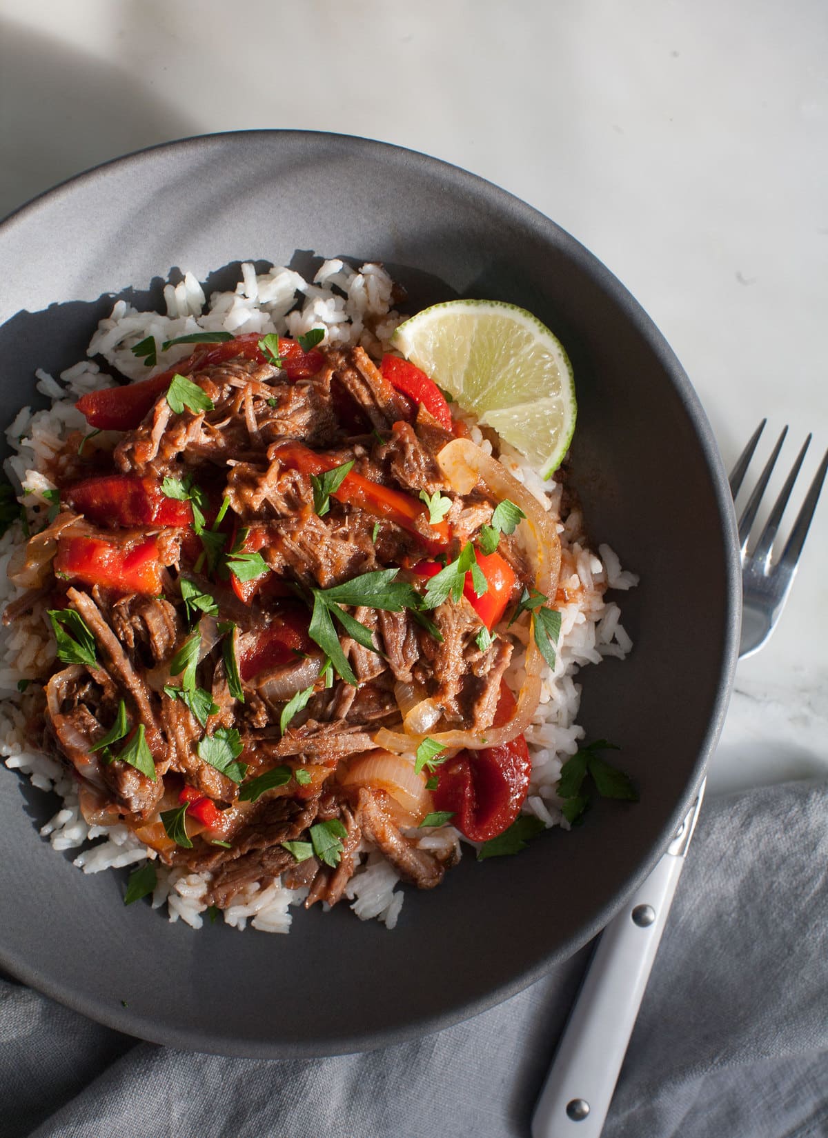 Rope Vieja in a bowl over rice. 