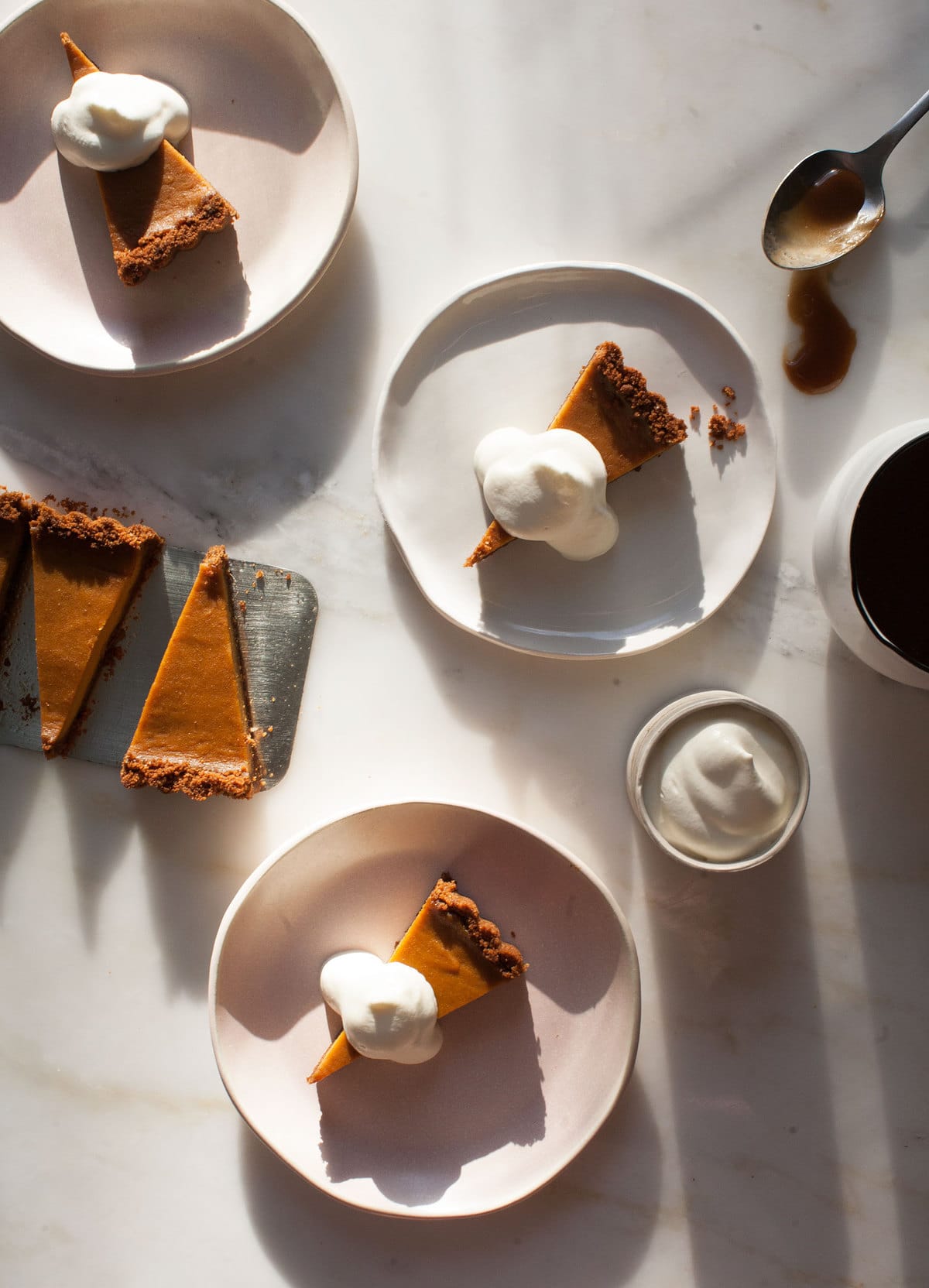 Butterscotch Pumpkin Pie on plates with whipped cream. 