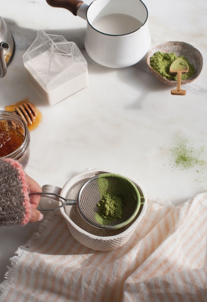 sifting matcha tea leaves