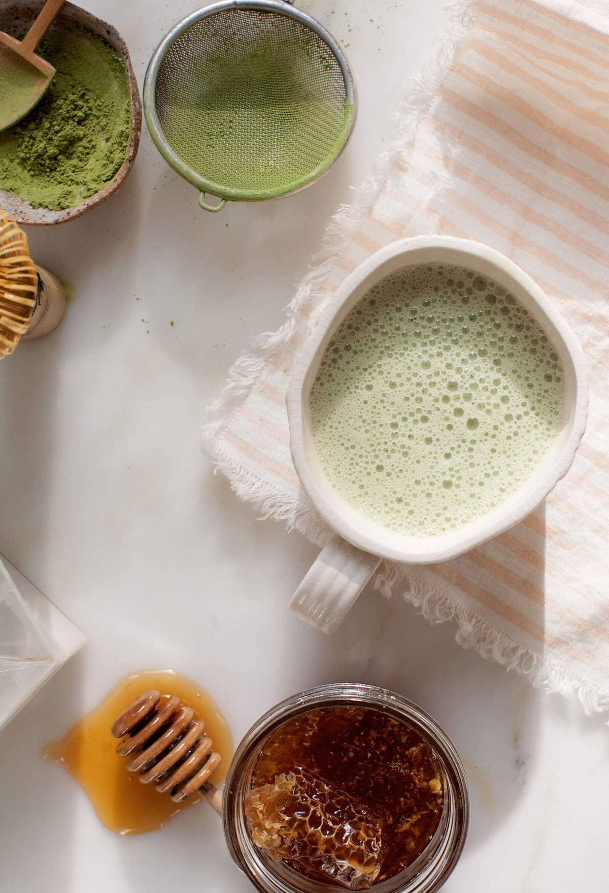 overhead shot with honey, matcha, matcha latte and linen