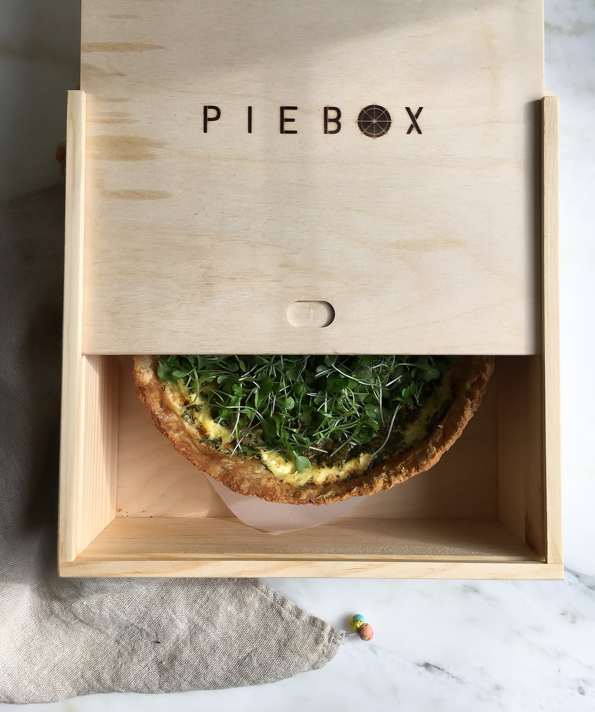 Quiche with Gruyére in a piebox. 