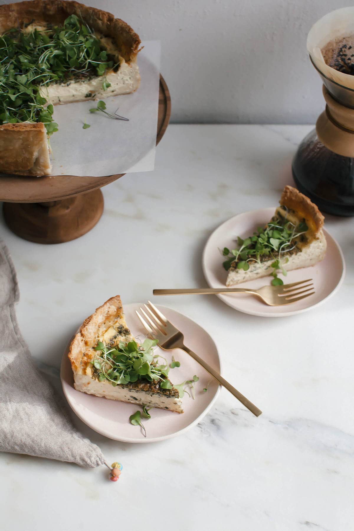 Quiche with Gruyére in slices on plates. 