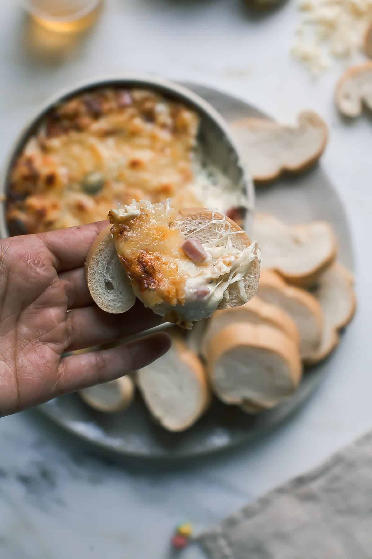 Warm Cuban Sandwich Dip with a scoop taken out. 