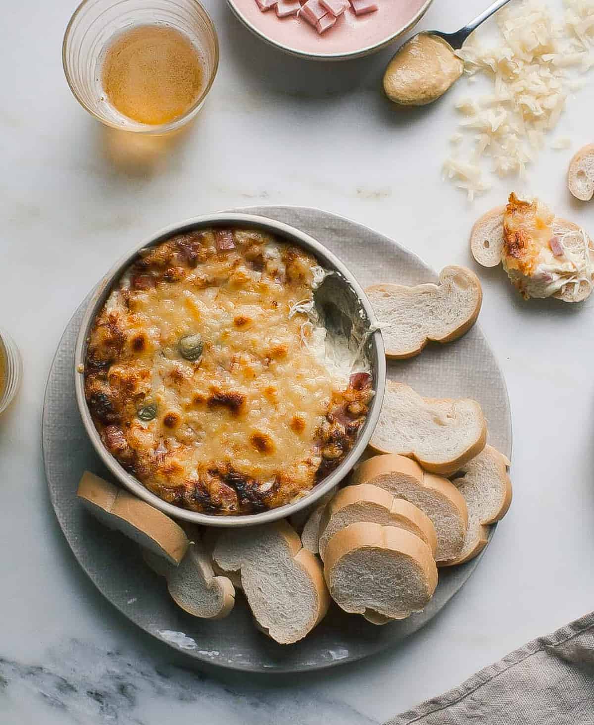 Warm Cuban Sandwich Dip with a scoop taken out. 