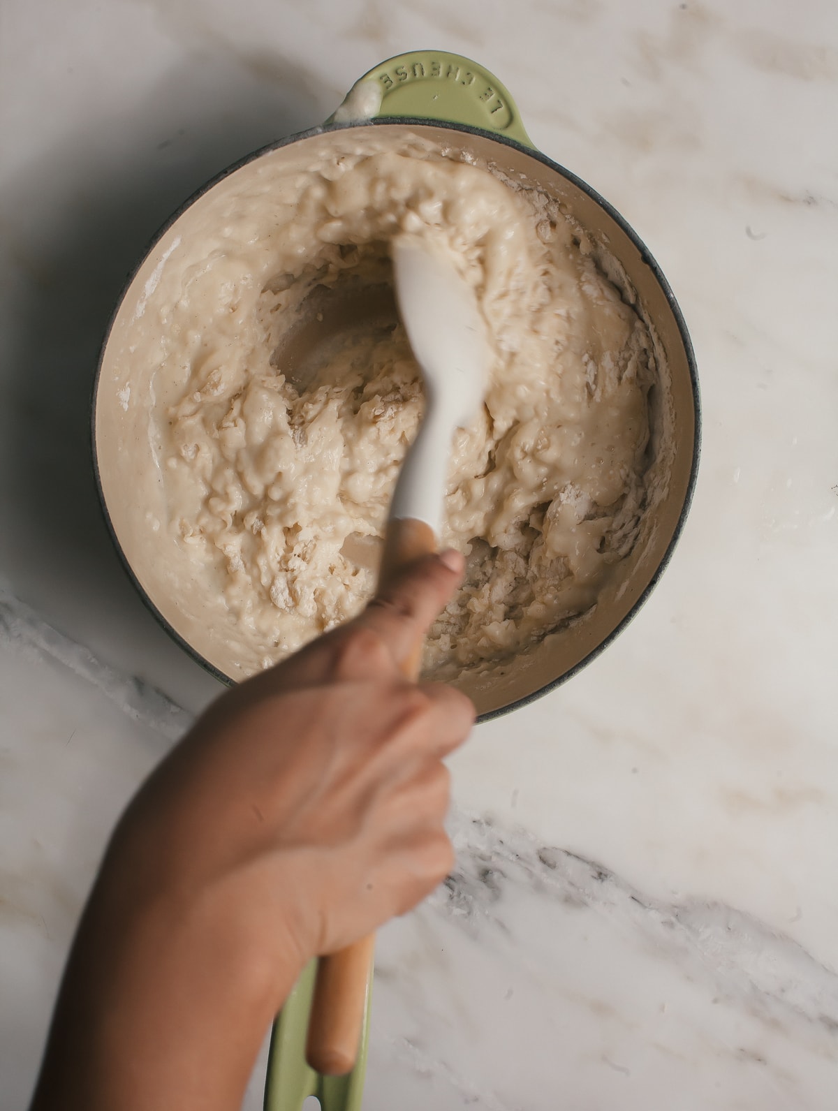 Flour being mixed into dough. 