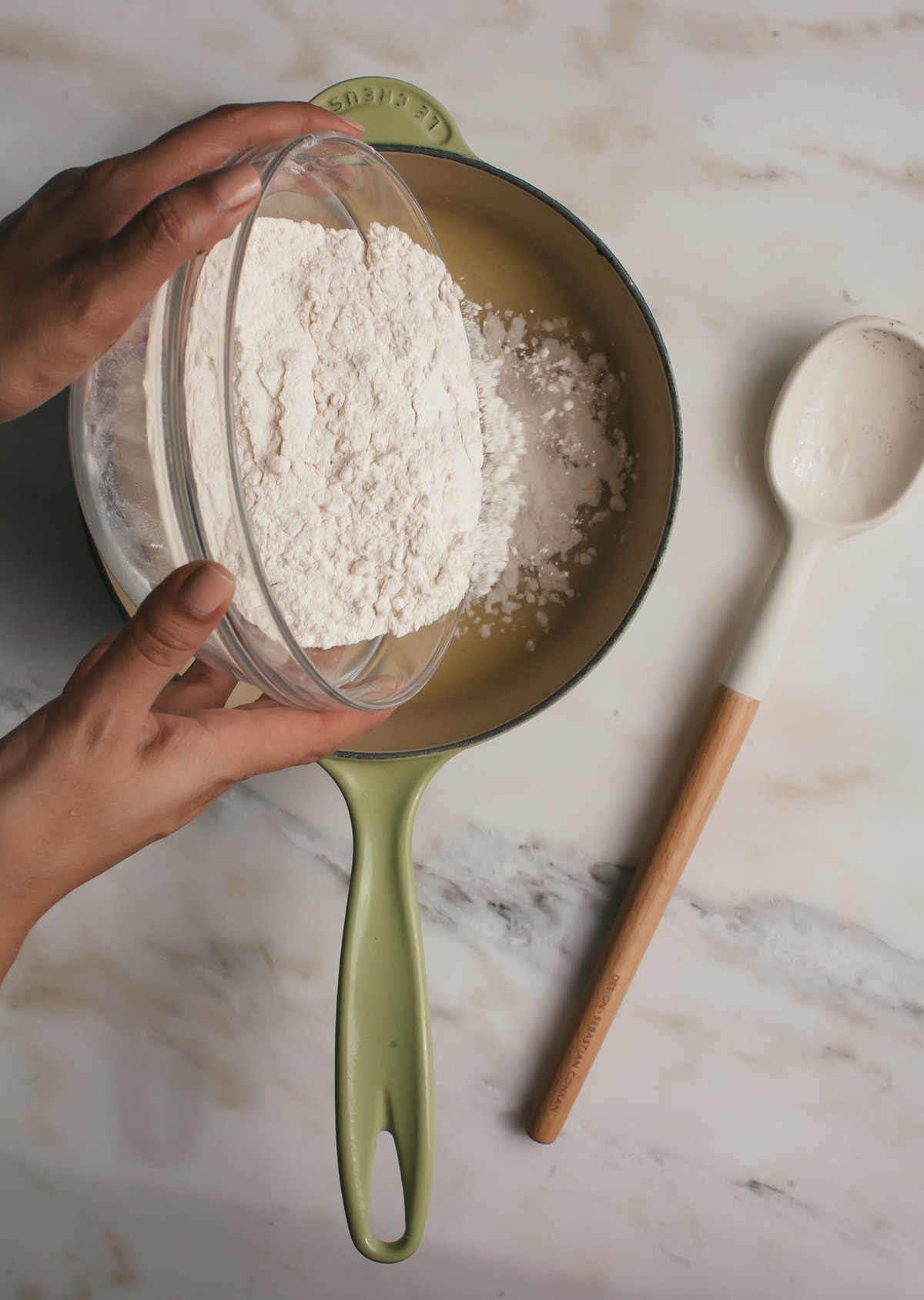 Flour being added to pot. 