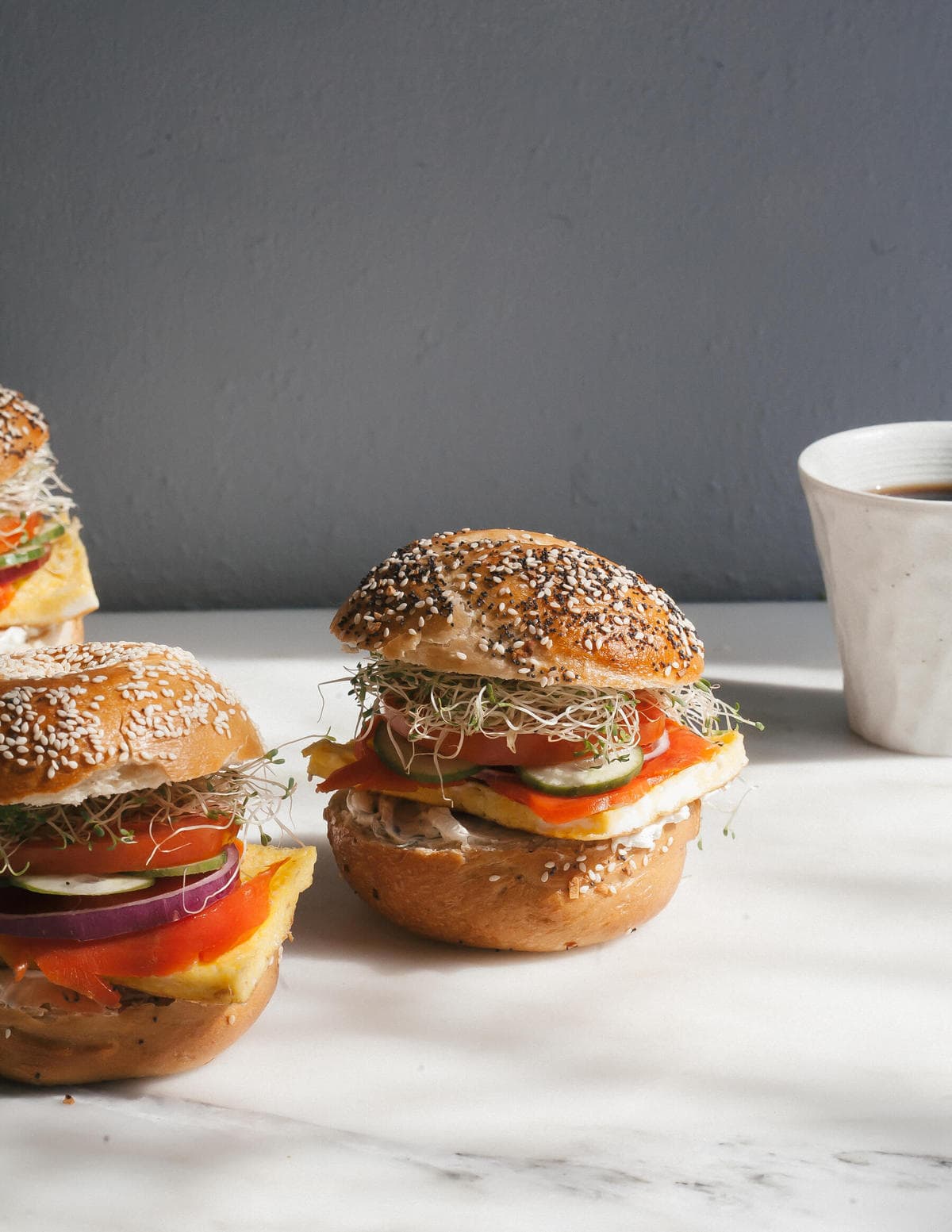 Bagel Sandwich with coffee on the side. 