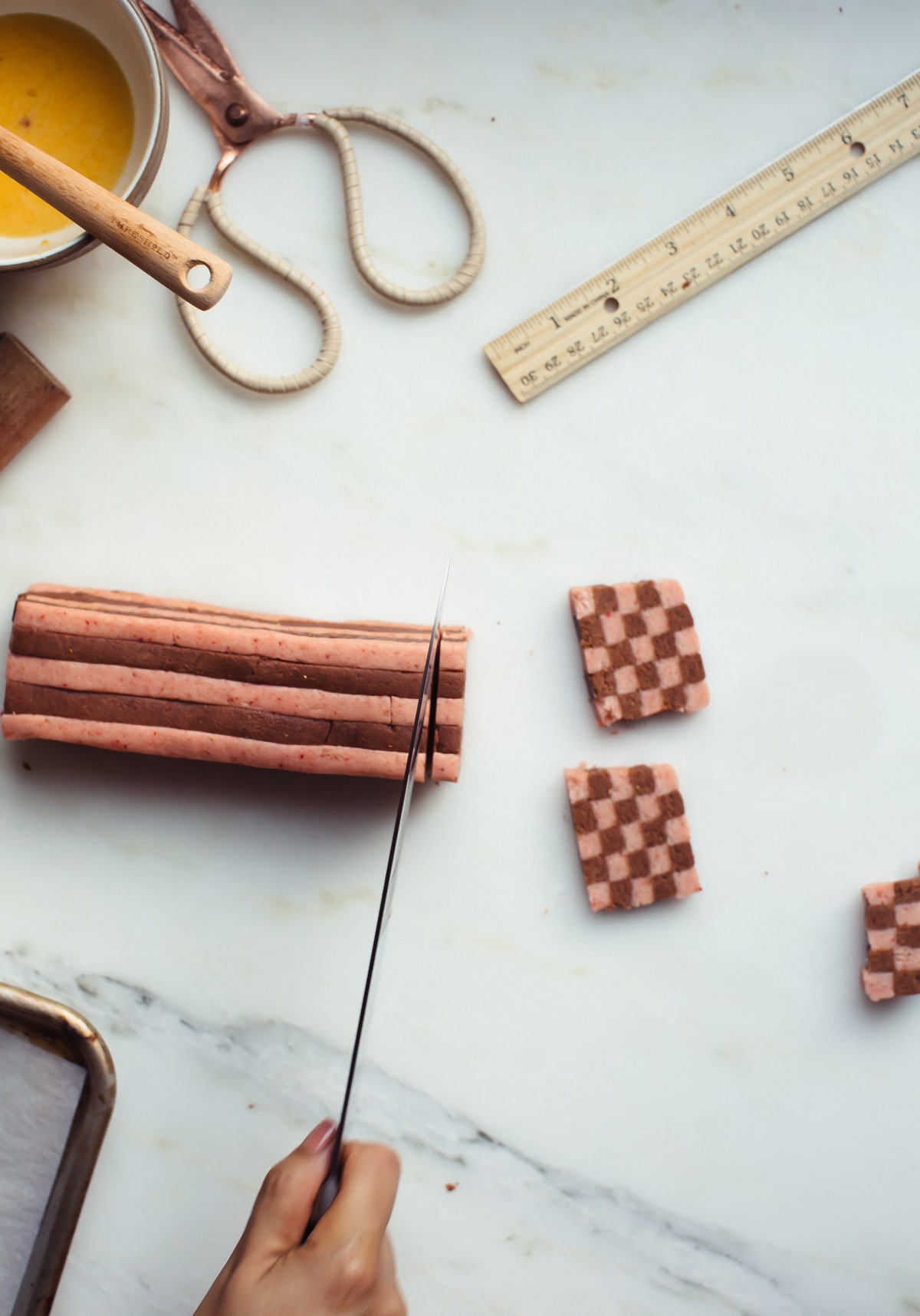 Strawberry Chocolate Checkered Cookies being sliced.