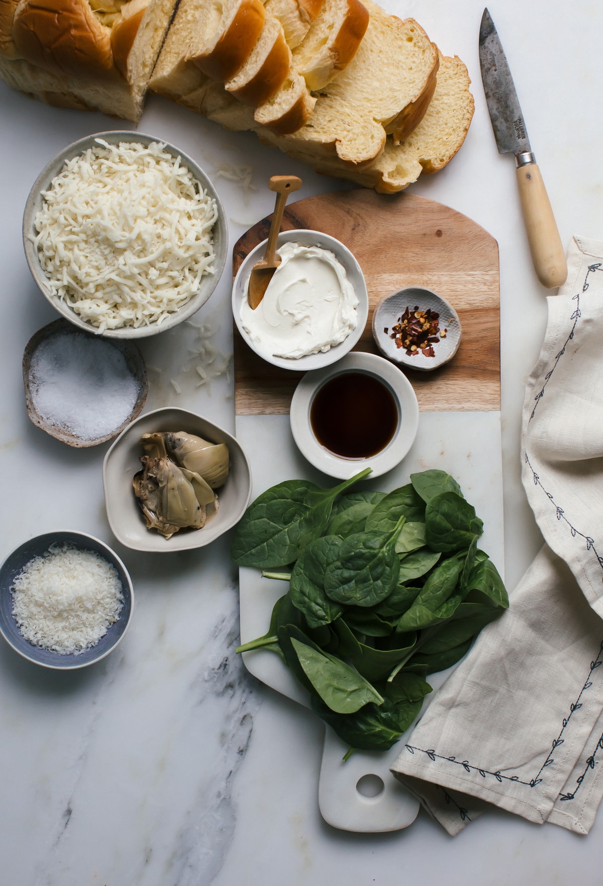 Spinach & Artichoke Dip Grilled Cheese ingredients on a counter.