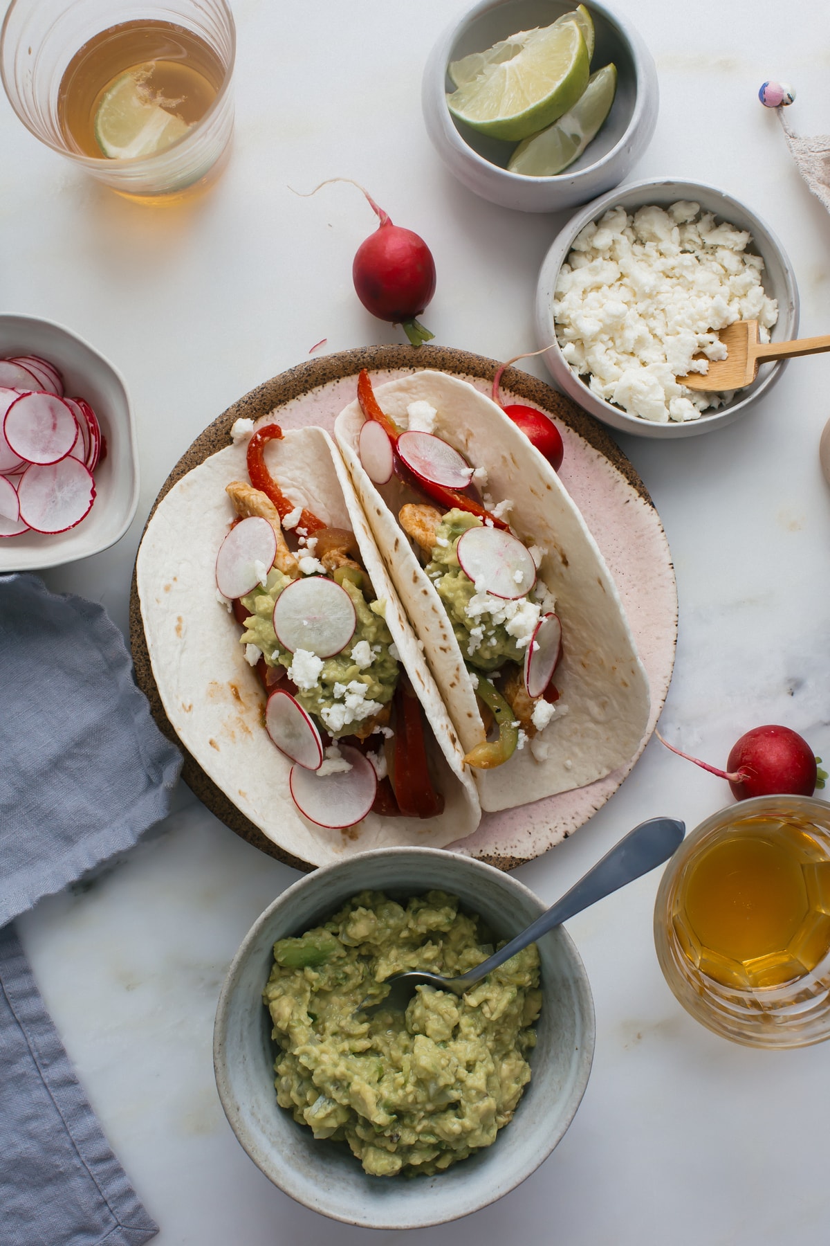 Overhead image of chicken faijtas on a plate loaded with toppings.