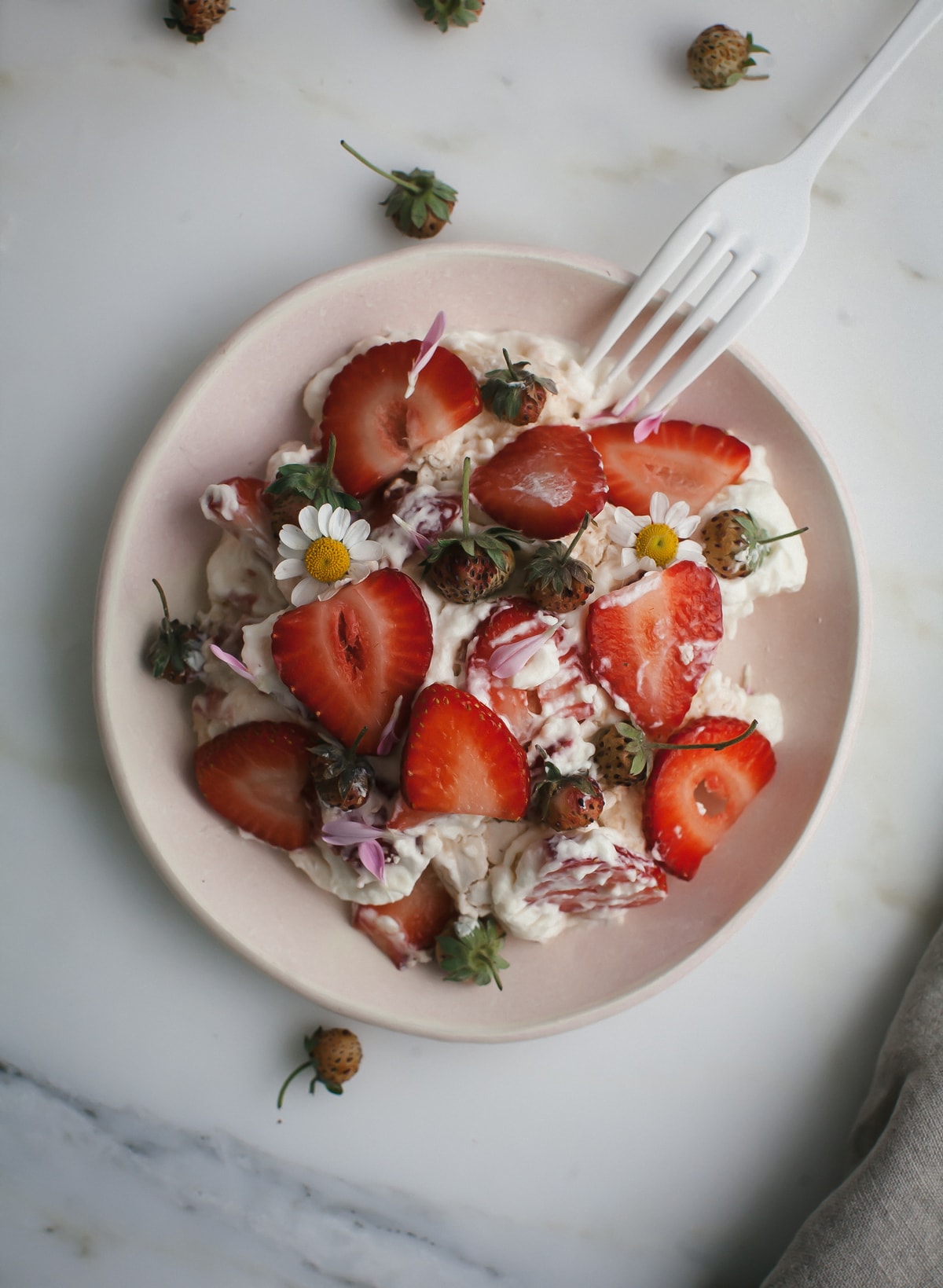 Eton mess on a plate with a fork. 