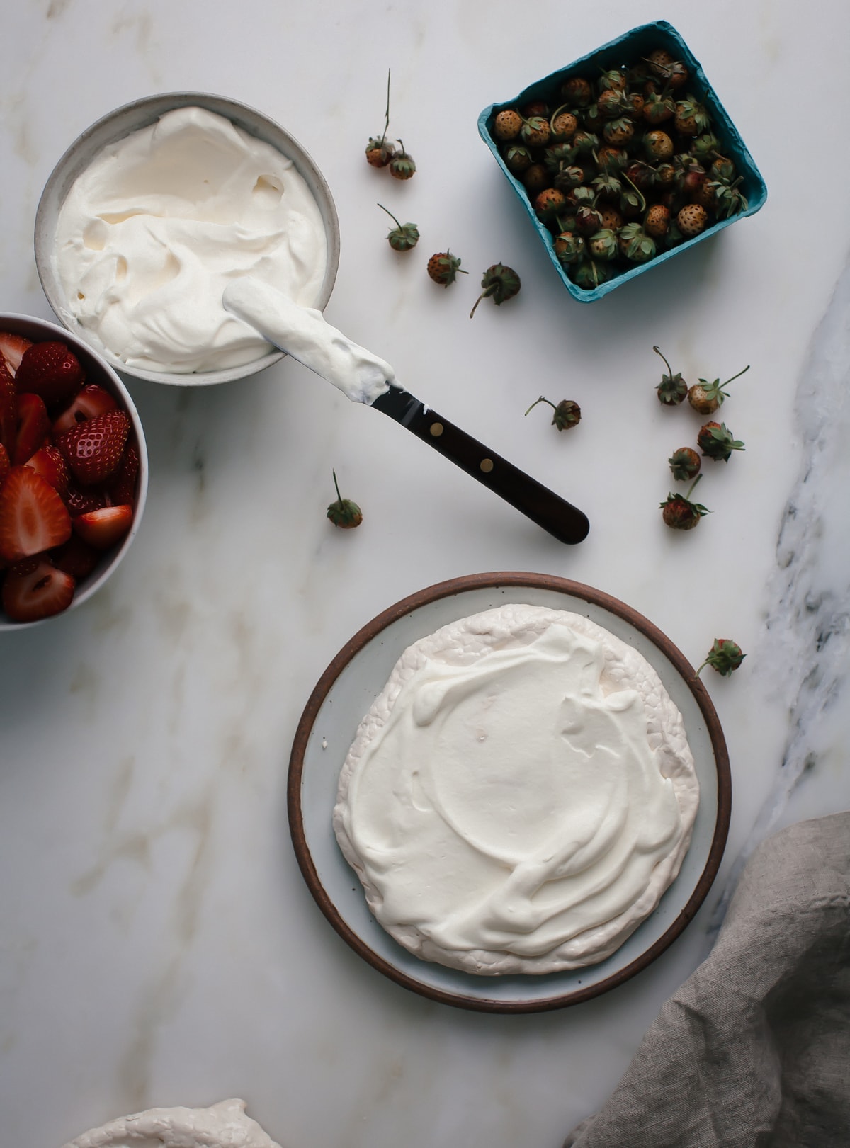 Pavlova on a plate with whipped cream. 