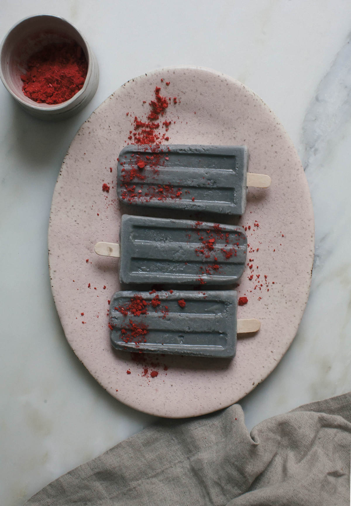 Close up image of black sesame popsicles on a plate.