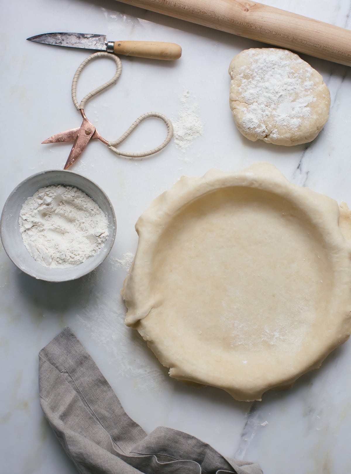 Homemade pie crust on a pie pan.