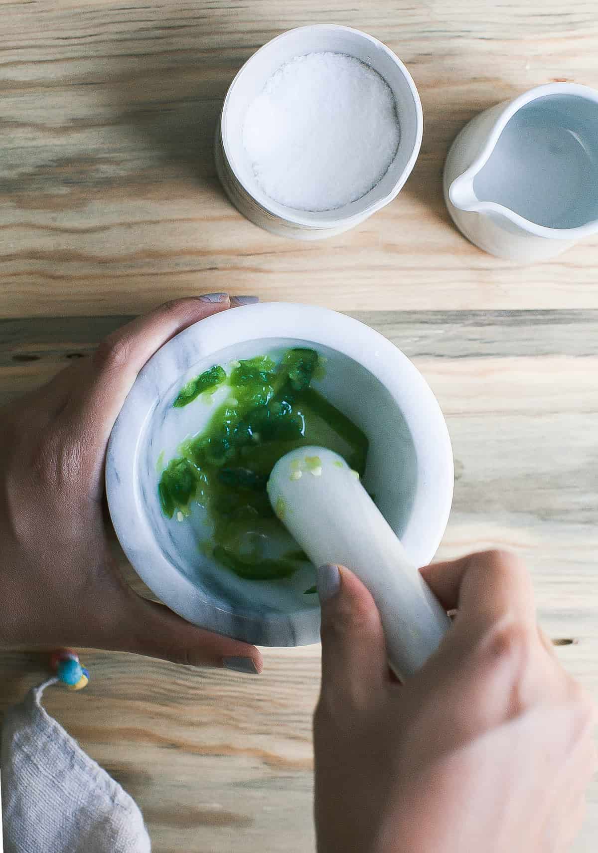 Jalapenos in a mortar and pestle.