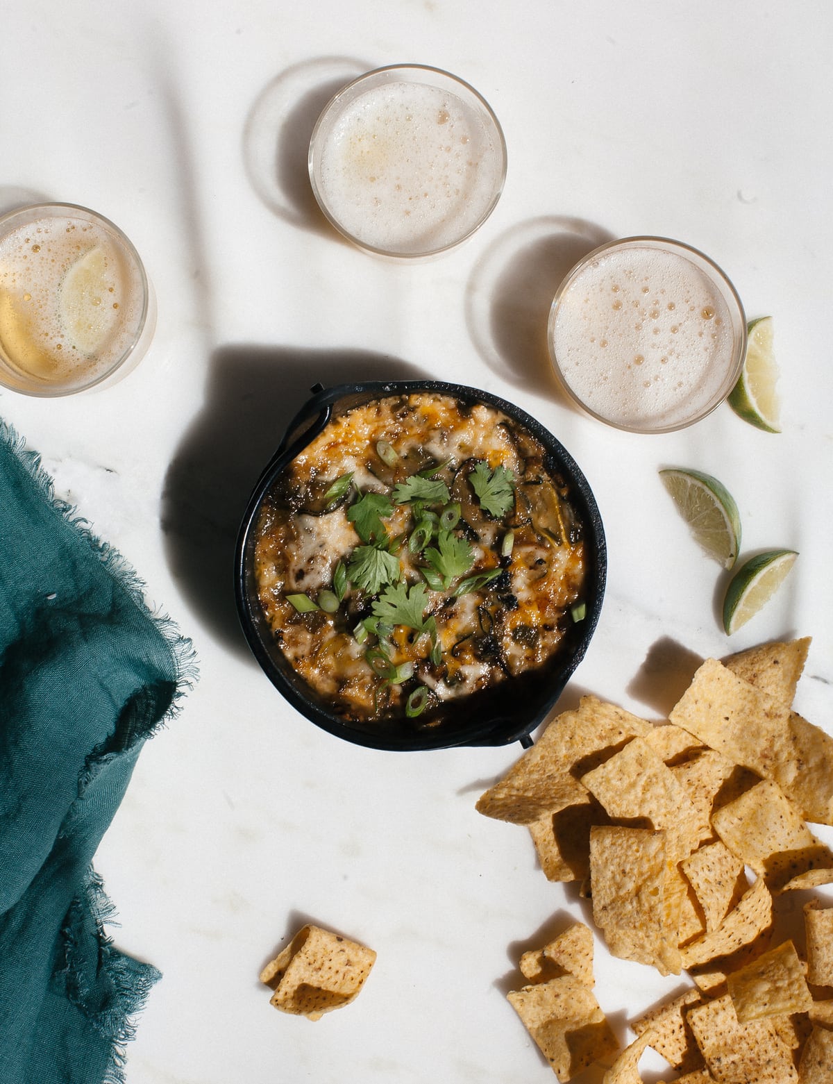 Cheese pepper dip served with tortilla chips and beer. 