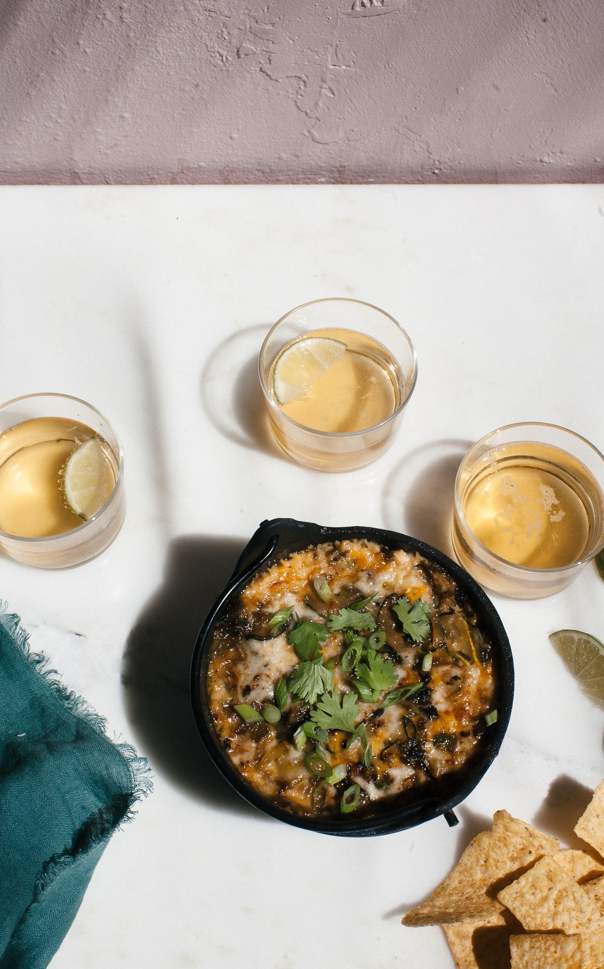 Close up image of summer squash queso fundido in a serving dish.