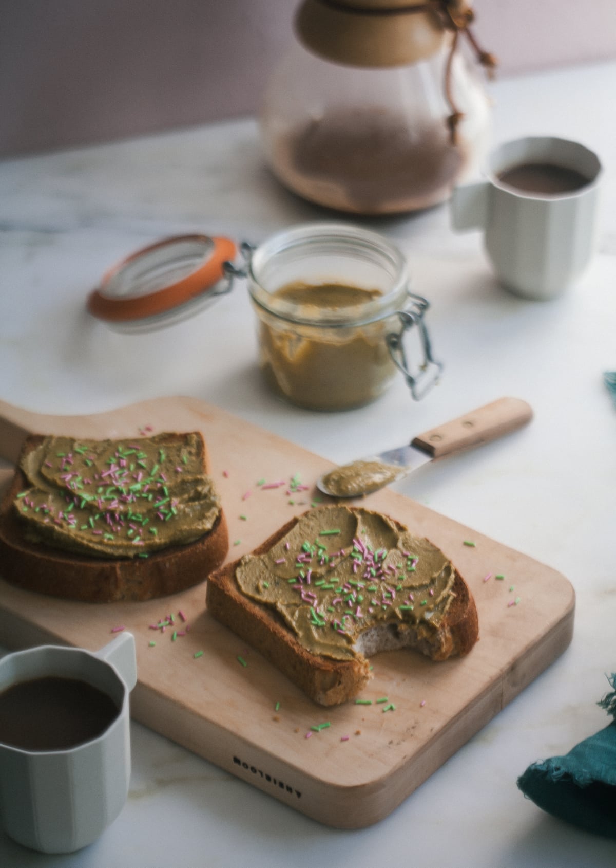 Pistachio butter on toast with sprinkles.
