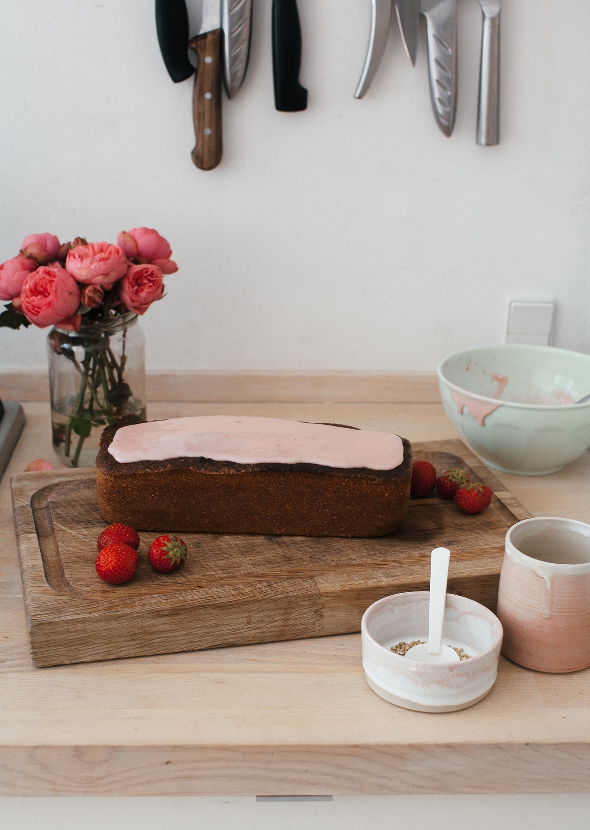 Glazed loaf cake on a cutting board. 