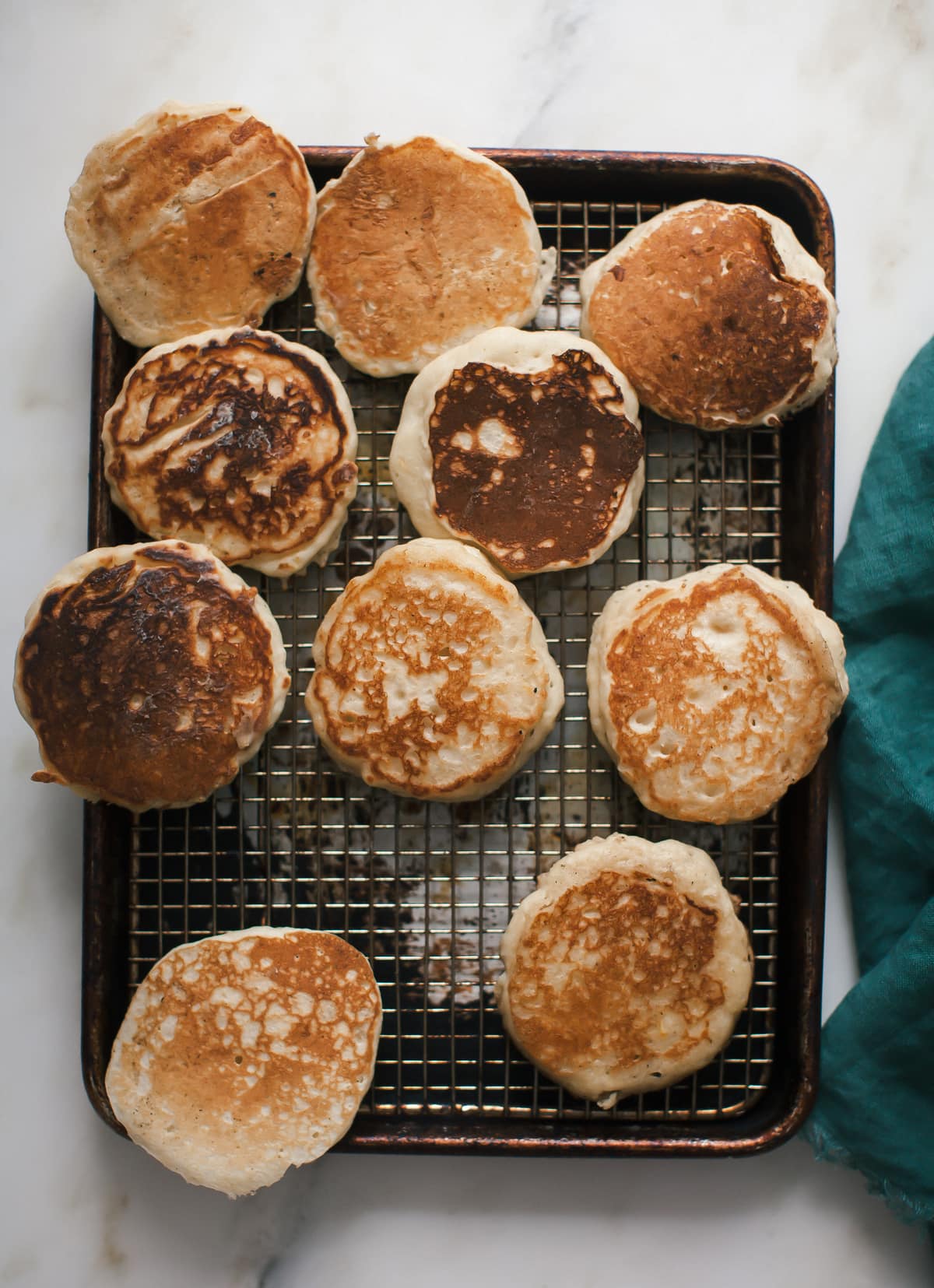 Pancakes resting on a wire rack. 