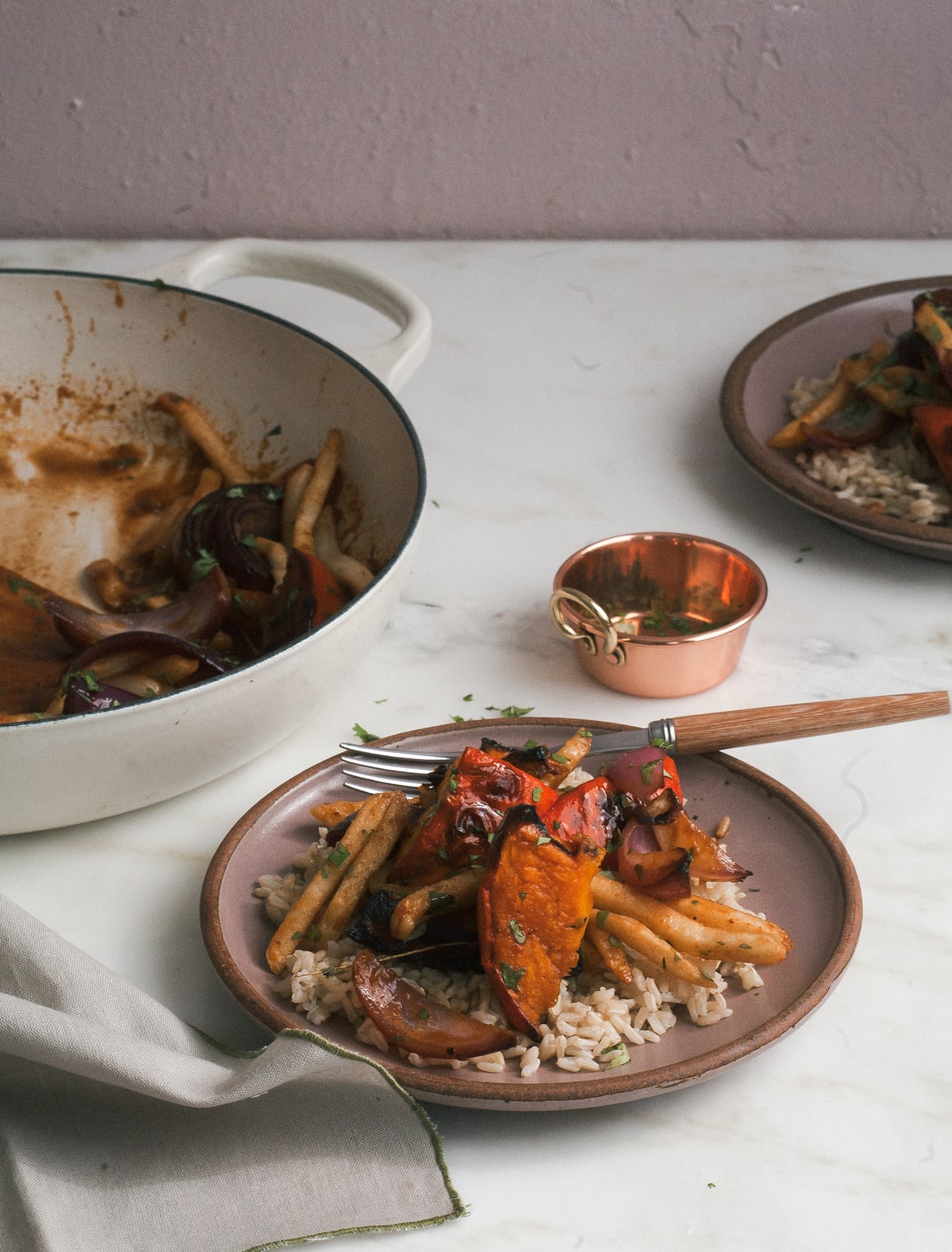 Side view of squash saltado on a plate with rice.