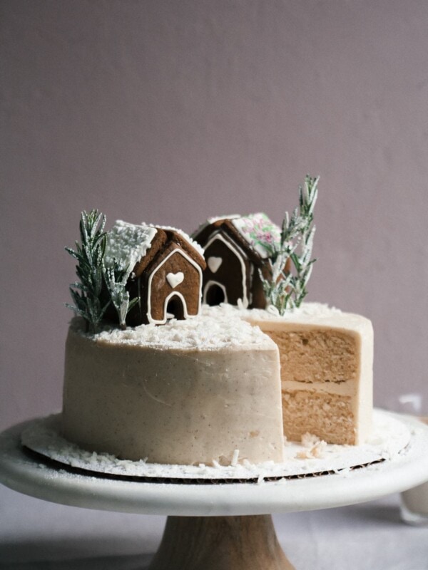 Side view of a decorated cake with a slice missing.